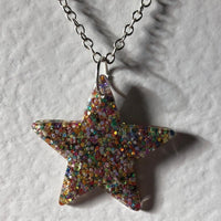 Lots of colours , Glitter star necklace, pendant on a gold or silver chain. 18 inches