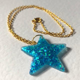 Lots of colours , Glitter star necklace, pendant on a gold or silver chain. 18 inches