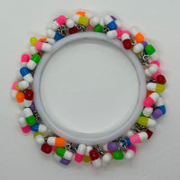 Encrusted Kitsch happy pill bangle bracelet. Rainbow bangle 2.6 inches diameter. Womens bangle