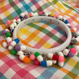 Encrusted Kitsch happy pill bangle bracelet. Rainbow bangle 2.6 inches diameter. Womens bangle